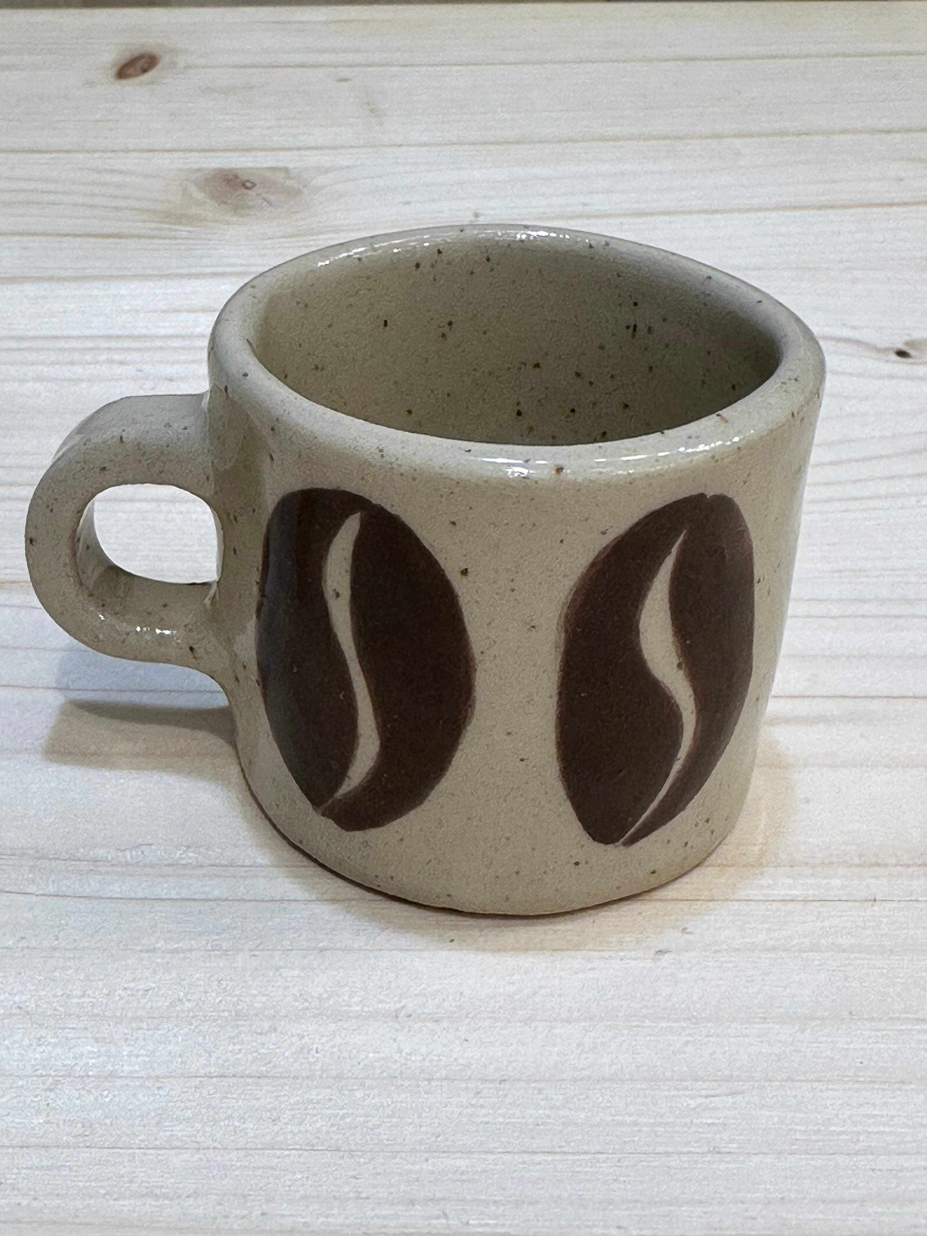 Espresso cup with a big coffee beans